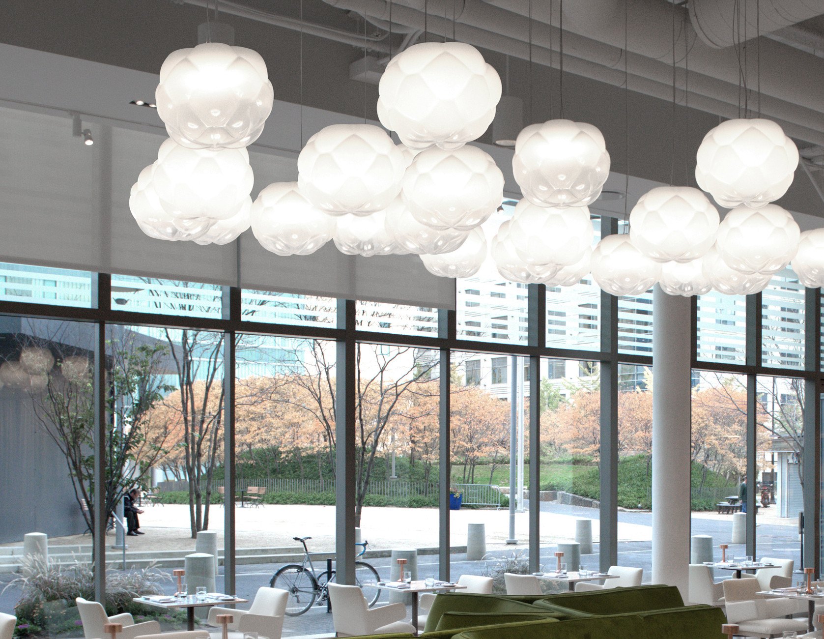 Clusters of Cloudy pendant lights in a large space · © Fabbian