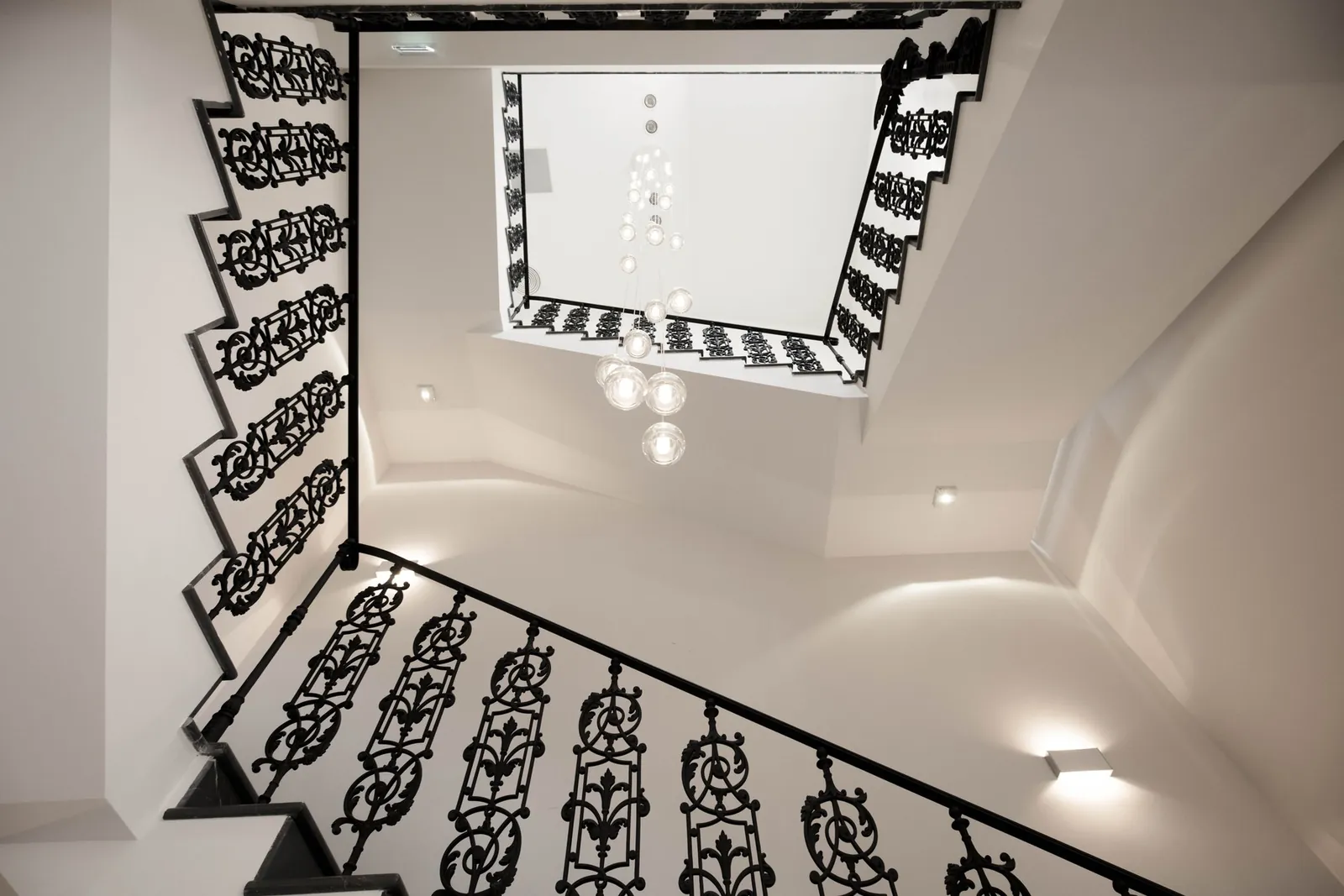 Komposition Multispot Beluga in einem Treppenhaus mit schmiedeeisernem Geländer · © Fabbian