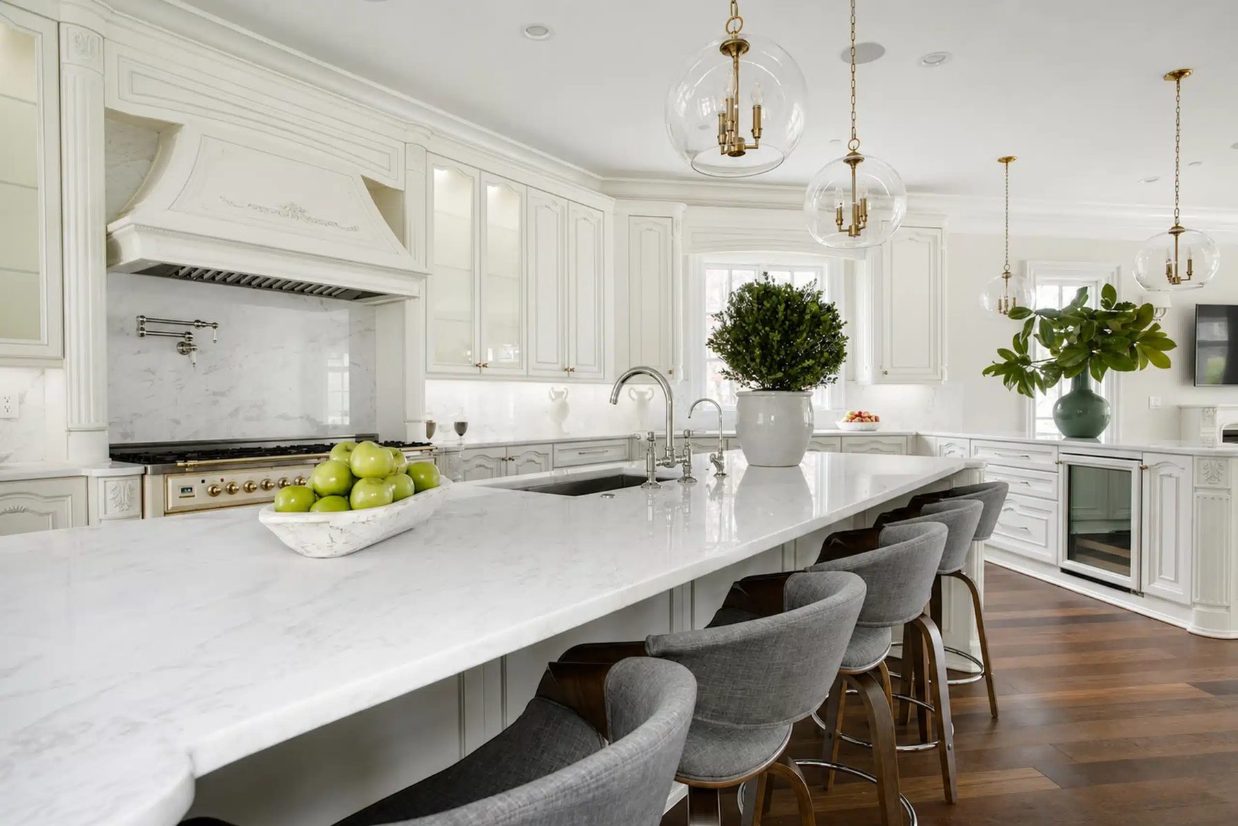 White kitchen, large marble island · Project and image © Martini Interiors