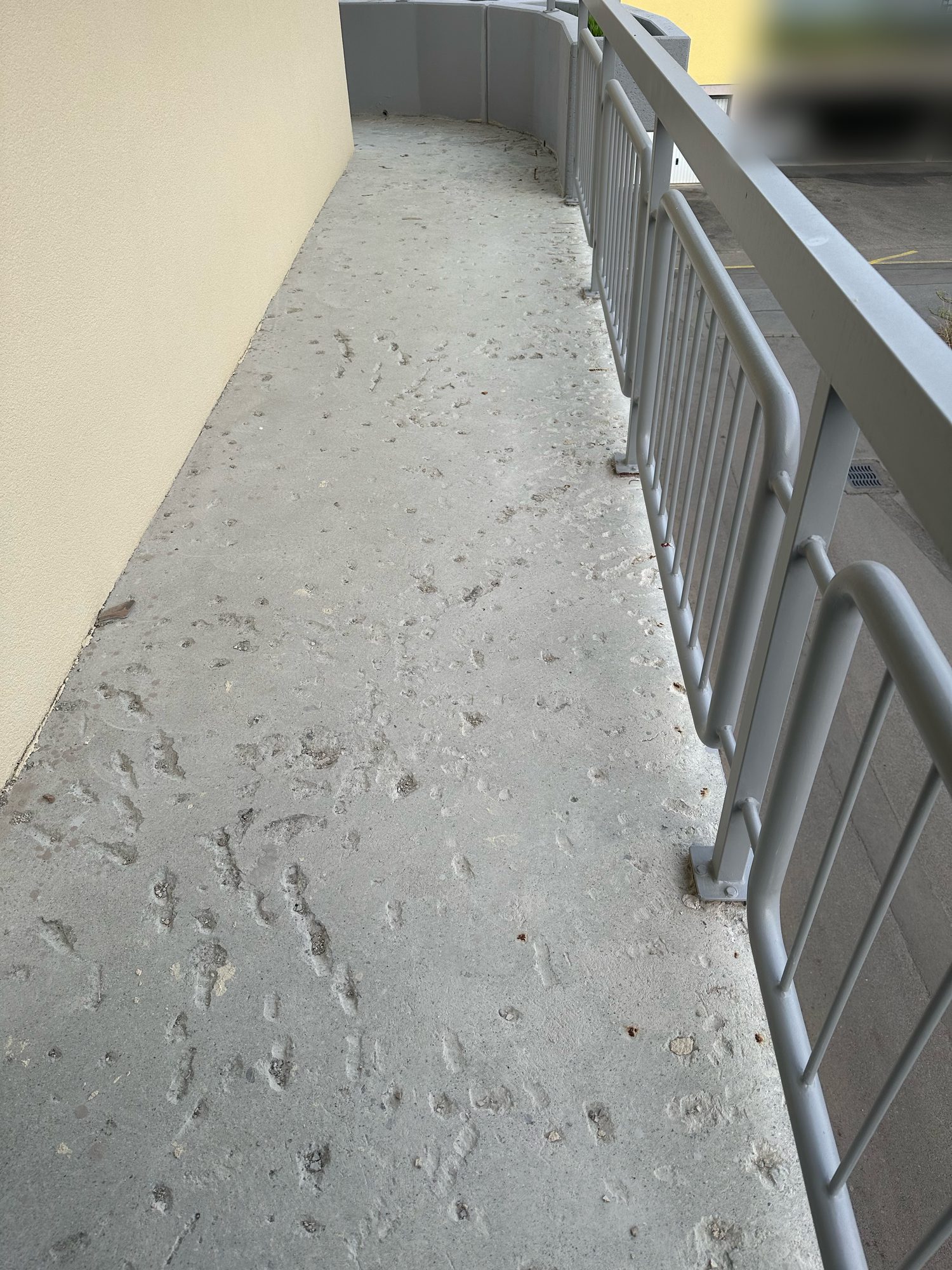 Walkway with a damaged concrete floor, before the work