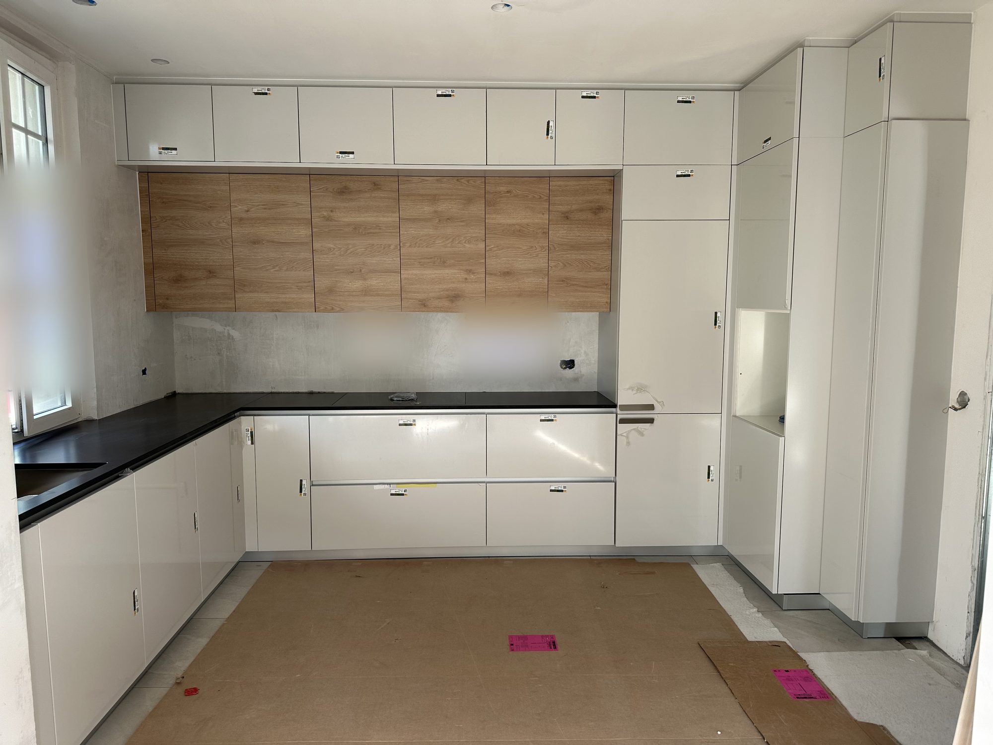 Large white U-shaped kitchen with wooden wall units