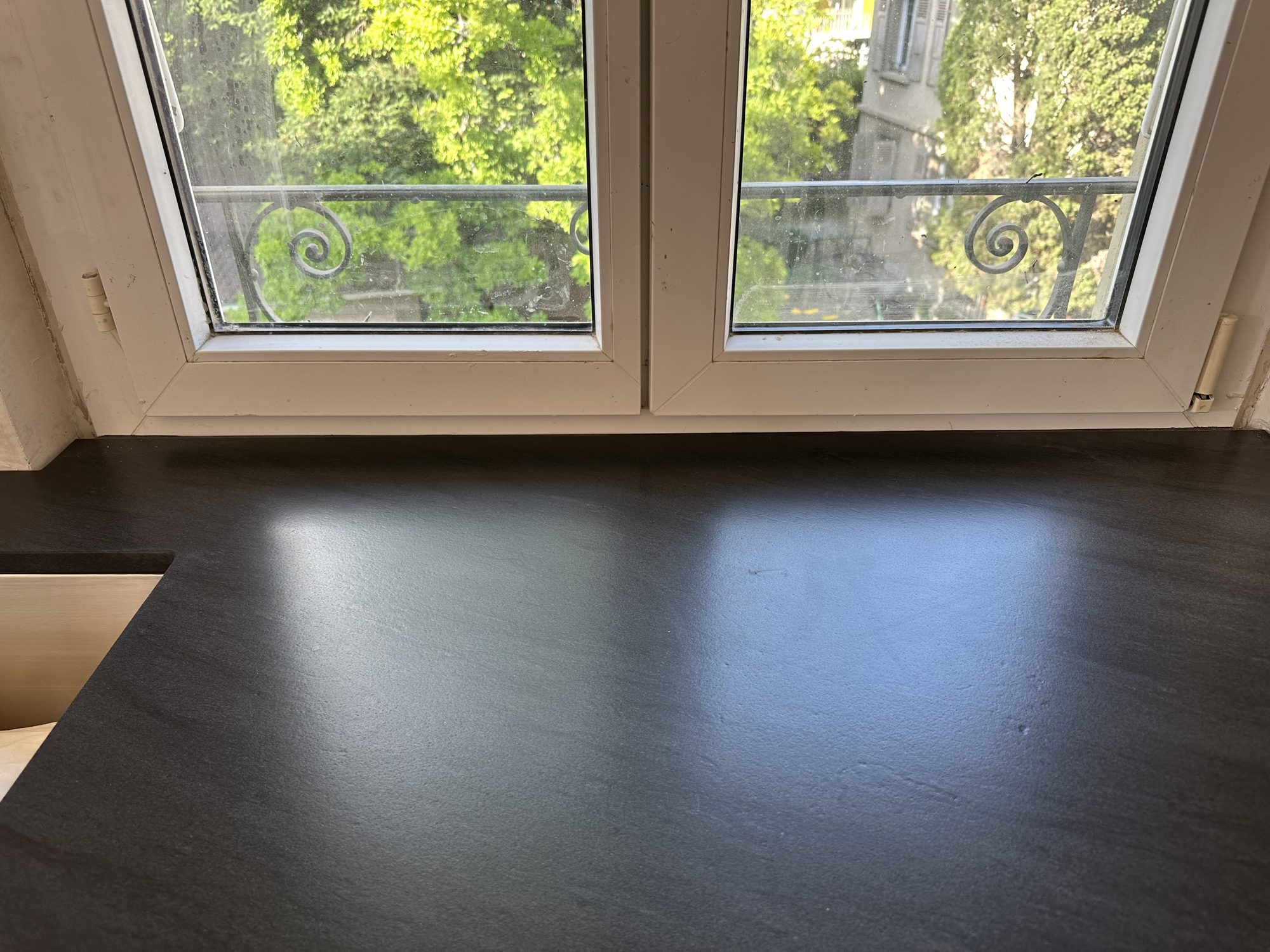 Black worktop in front of a window