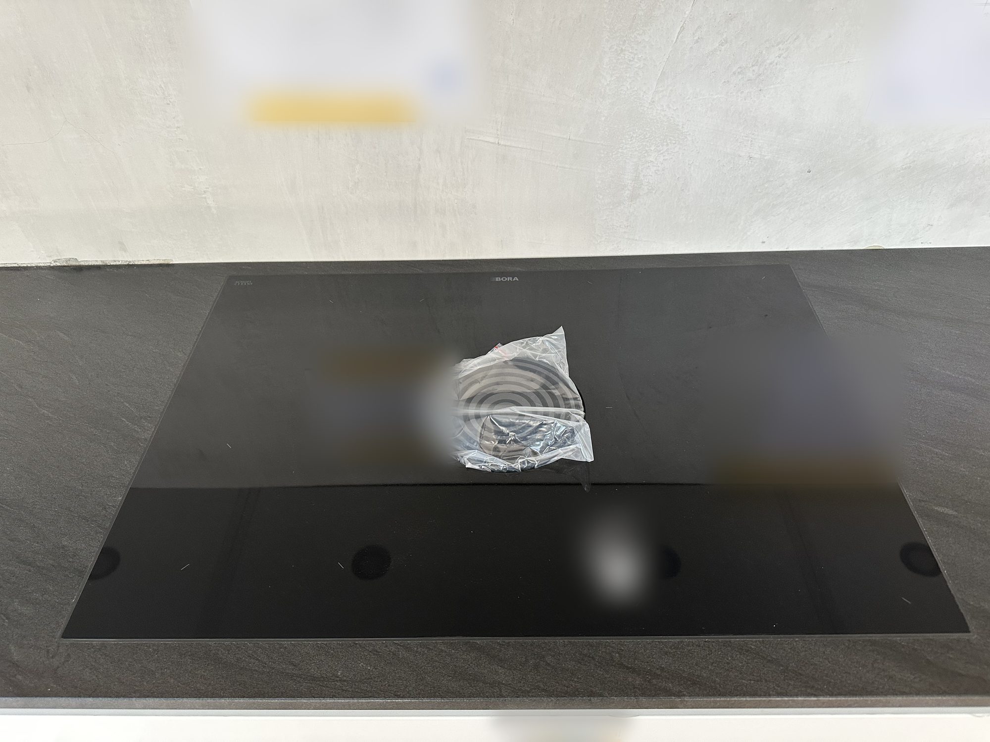 Detail of the hob on the black worktop