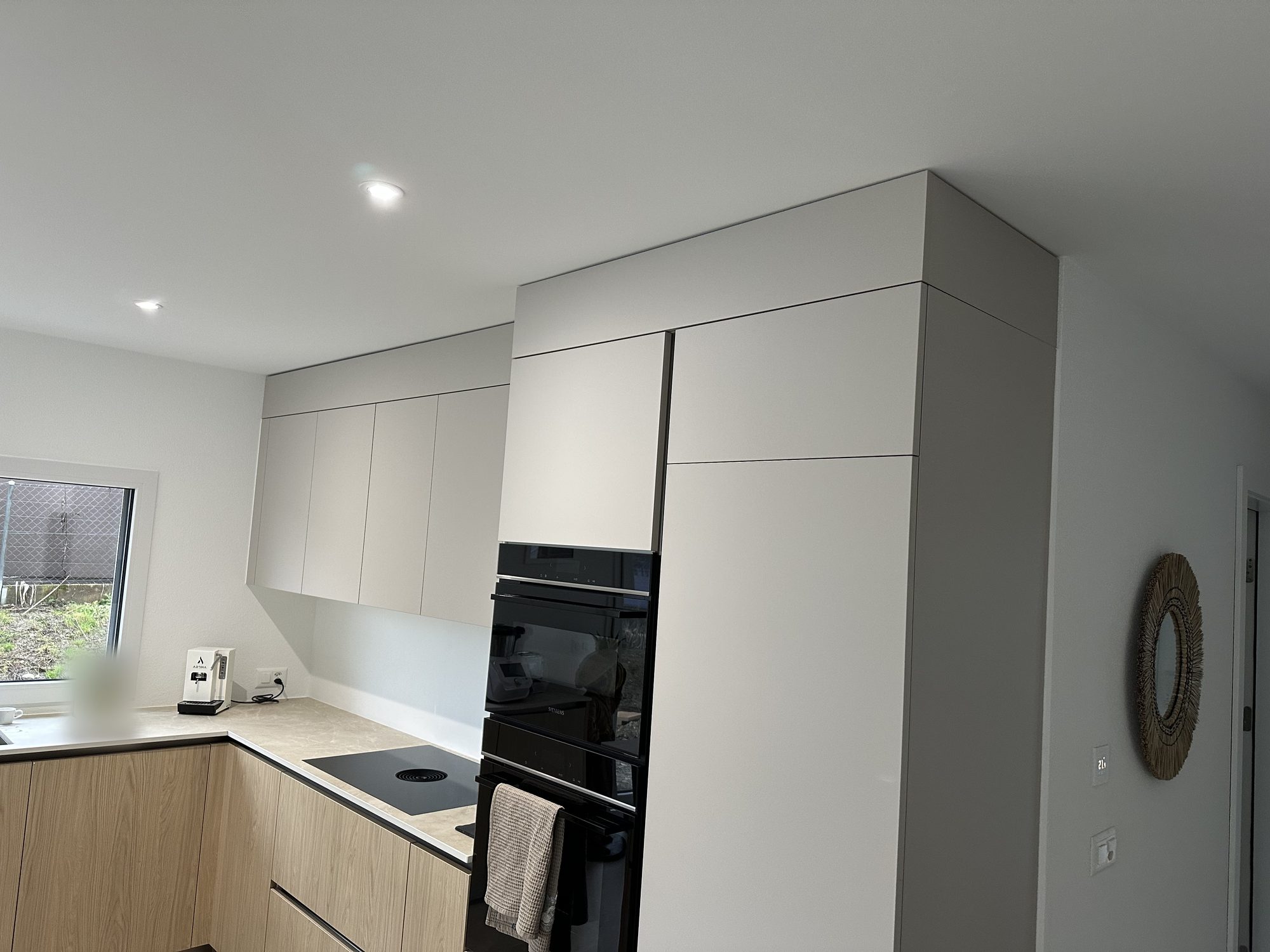 Light grey and wood L-shaped kitchen, another angle