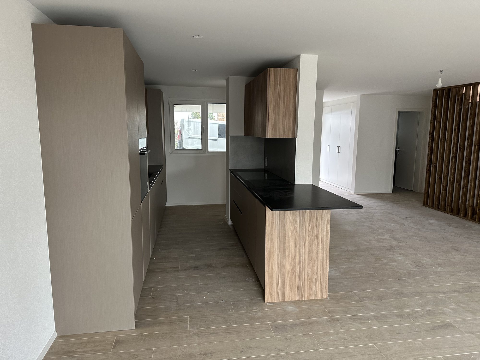Wooden island with a black worktop