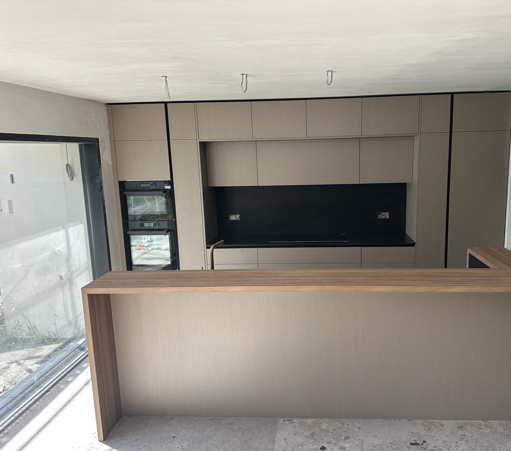 Taupe island with an overhanging wooden top