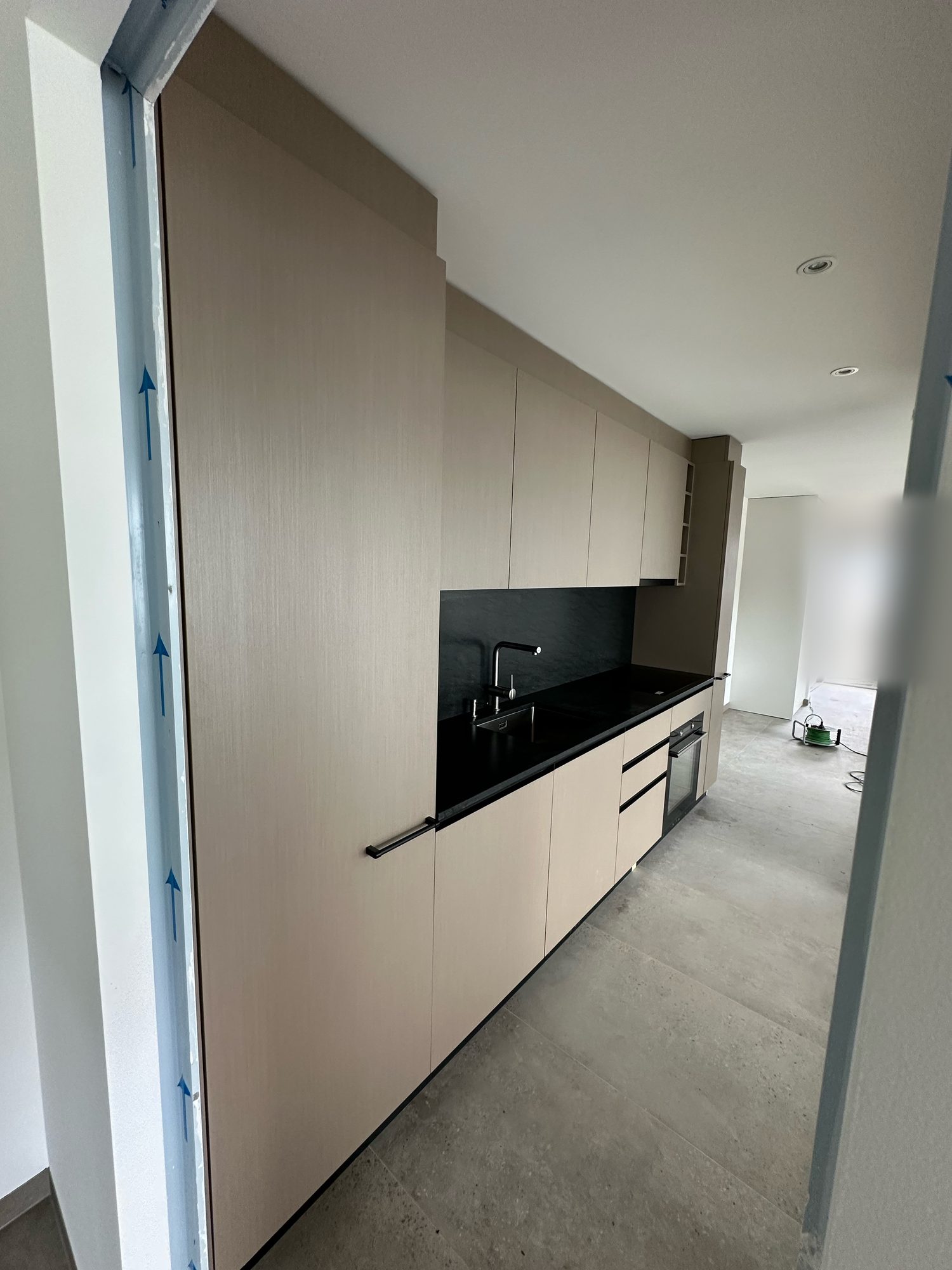 Black worktop and taupe fronts