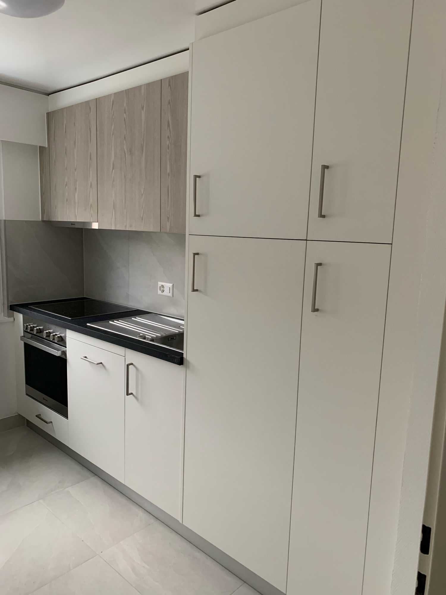 White tall units and black worktop
