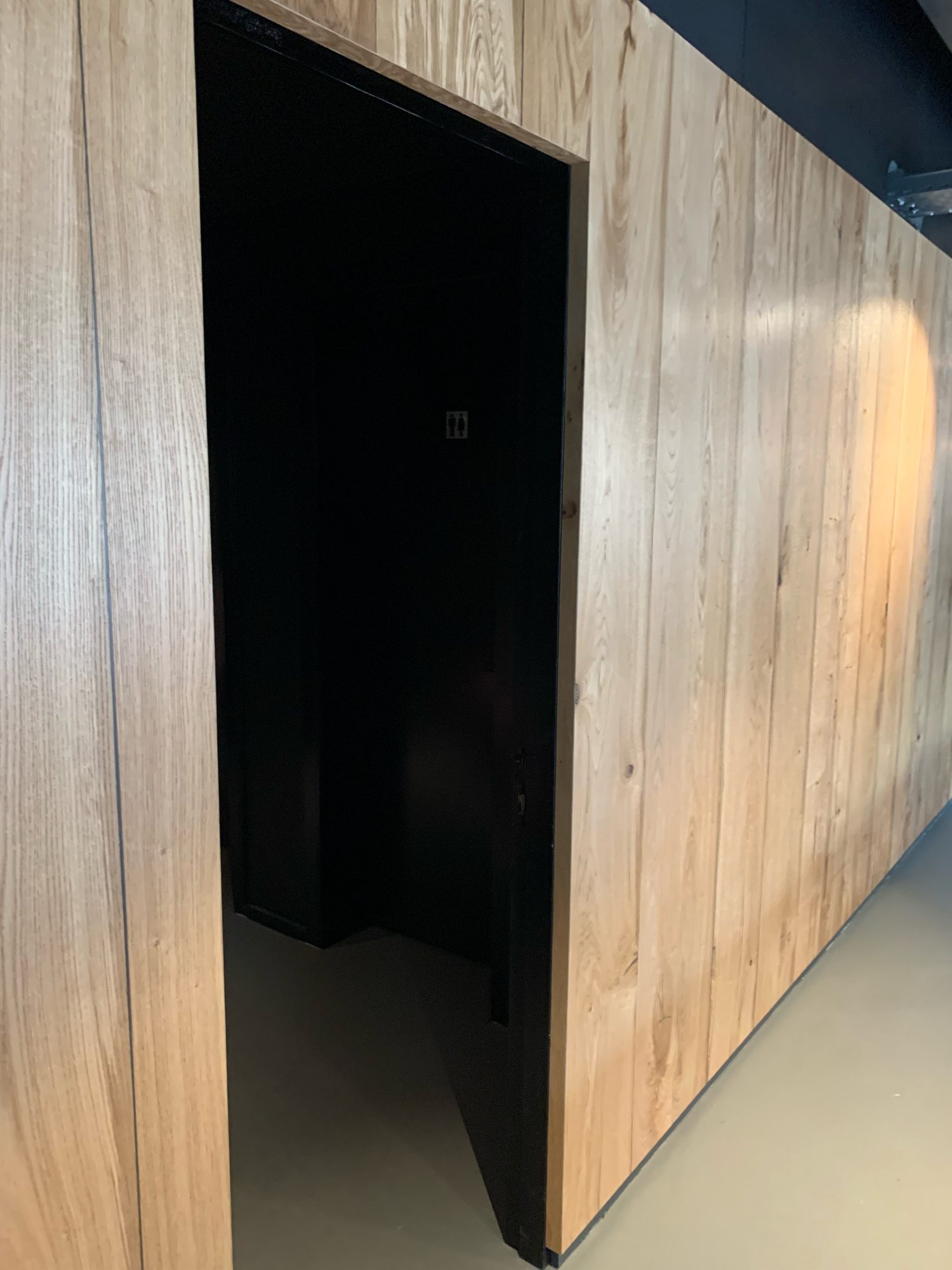 Black door built into the wood cladding