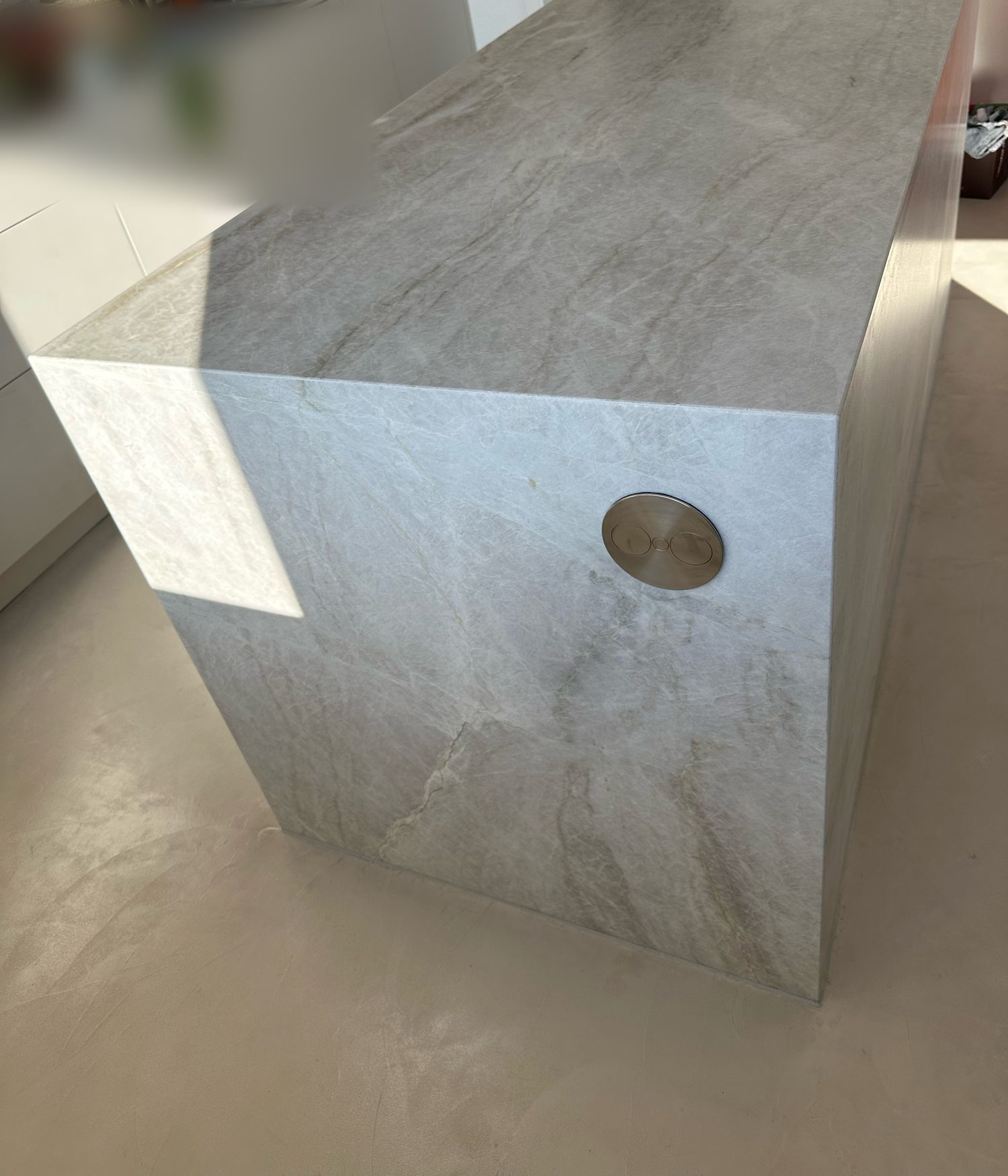 Island clad in veined grey stone