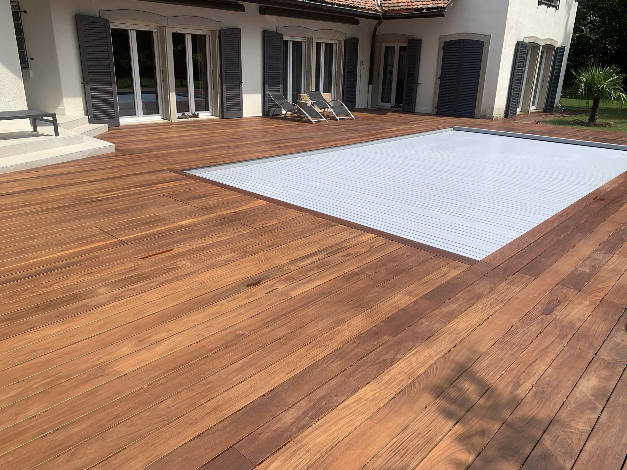 Wooden pool deck around the covered pool